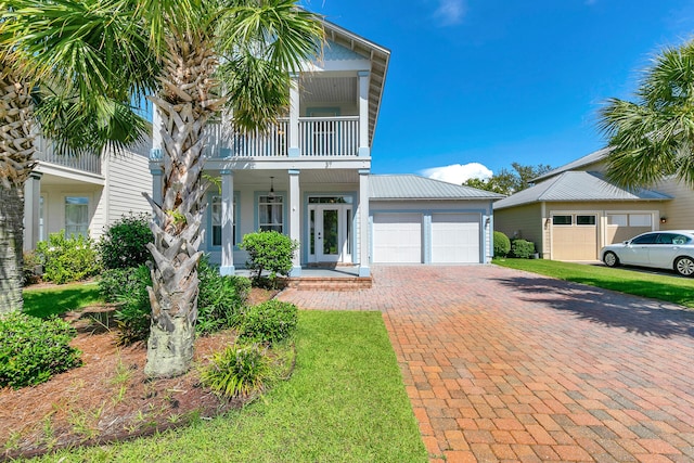 view of front of home with a balcony, a garage, and a porch