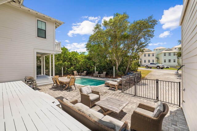 view of swimming pool featuring an outdoor living space and a deck