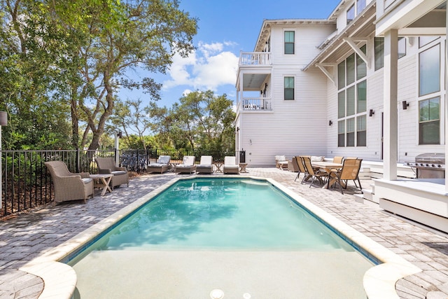 view of swimming pool with a fenced in pool, a patio, and fence