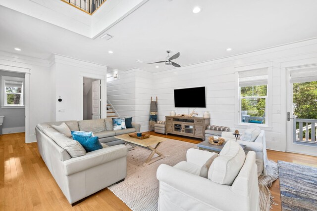 living room featuring ceiling fan and light wood-type flooring