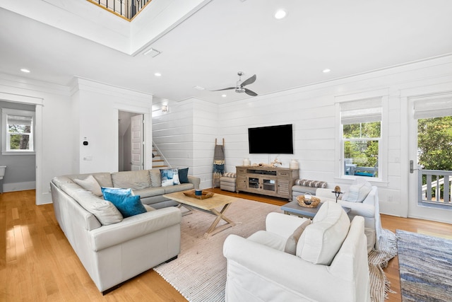 living room featuring recessed lighting, visible vents, ornamental molding, stairway, and light wood-type flooring