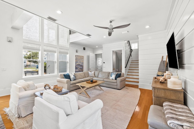 living room featuring ceiling fan, light hardwood / wood-style flooring, and ornamental molding