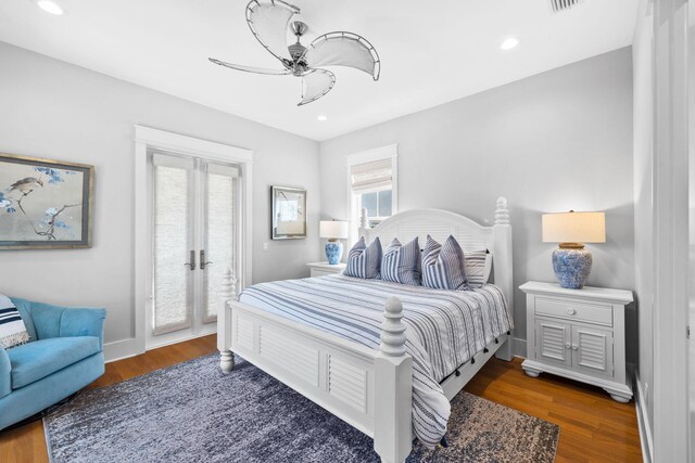 bedroom featuring ceiling fan, access to exterior, and hardwood / wood-style floors