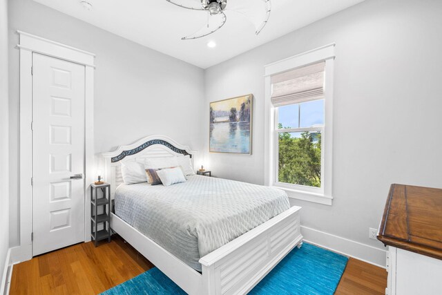 bedroom with ceiling fan and wood-type flooring