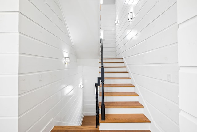 stairway with vaulted ceiling and wood finished floors