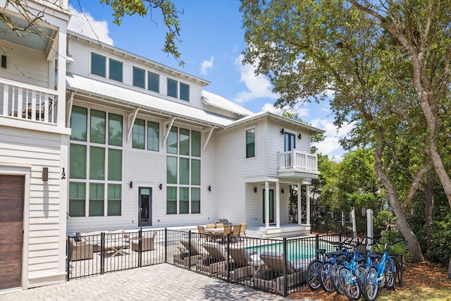 rear view of property with a patio area and a balcony