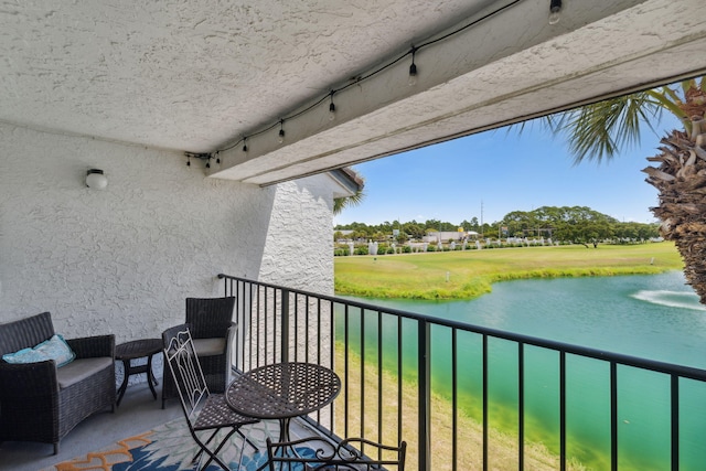 balcony featuring a water view