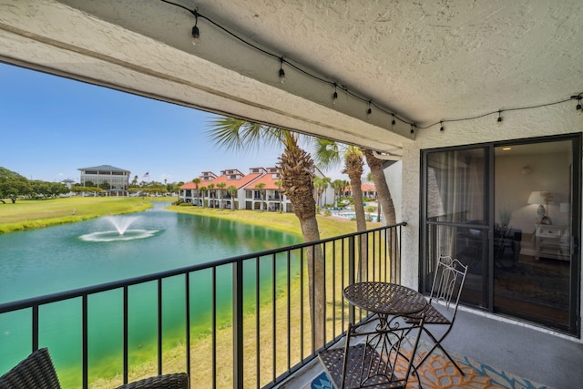 balcony featuring a water view