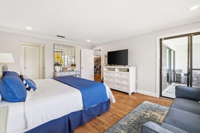 bedroom with light hardwood / wood-style floors, ornamental molding, and access to outside