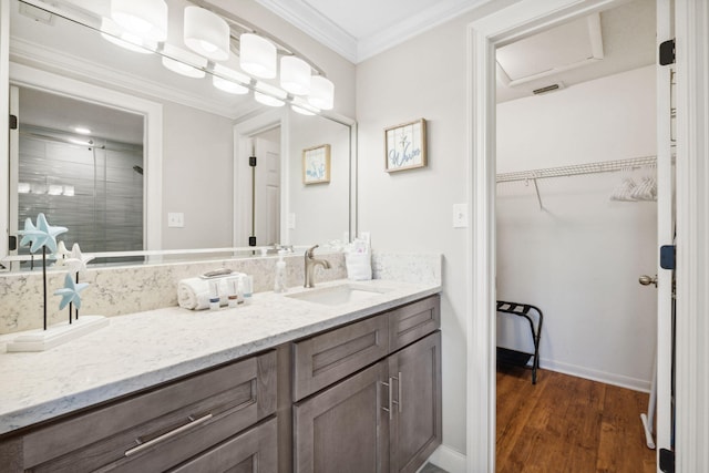 bathroom with hardwood / wood-style flooring, ornamental molding, and vanity