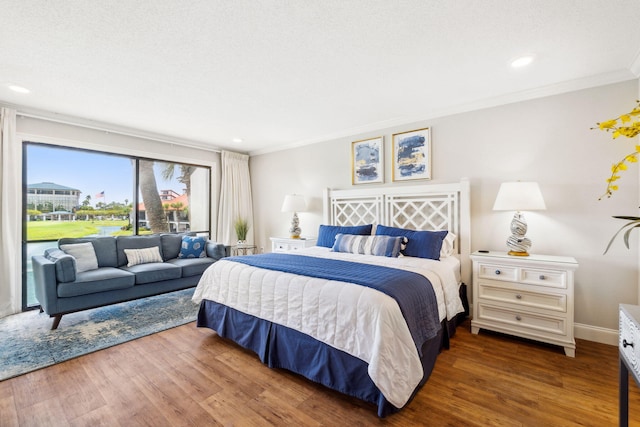 bedroom featuring ornamental molding and dark hardwood / wood-style floors