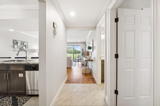 hallway with sink, light hardwood / wood-style flooring, and crown molding