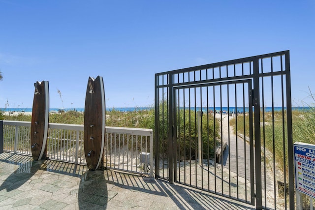 view of gate with a water view