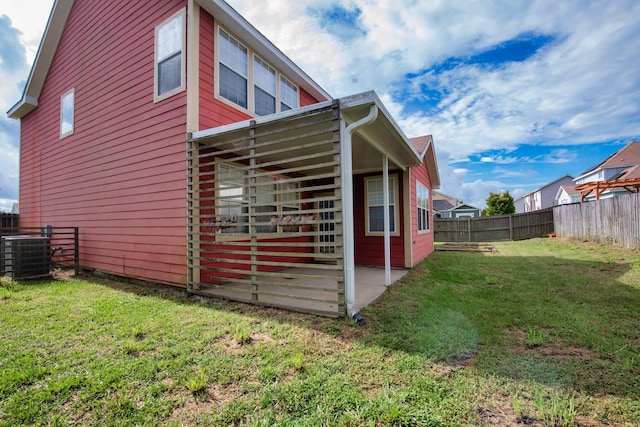 view of home's exterior with a yard and central air condition unit