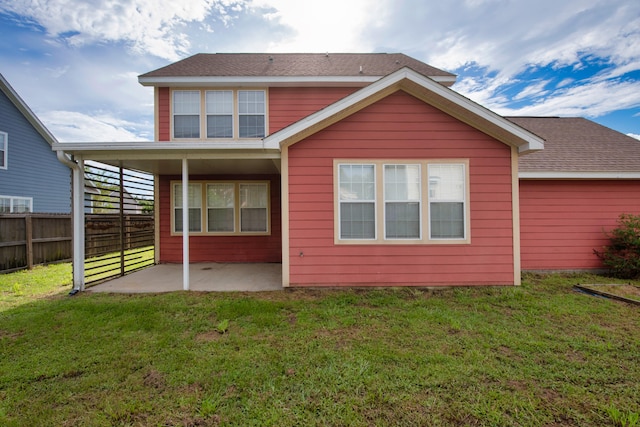 rear view of property featuring a yard and a patio