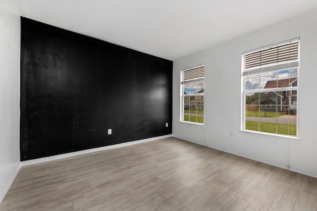 spare room with light hardwood / wood-style floors