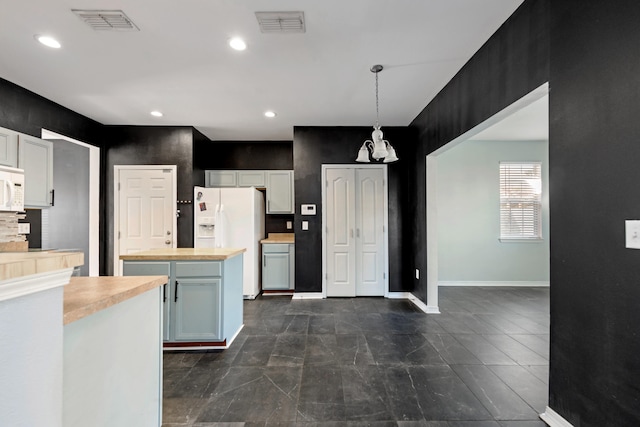 kitchen with white cabinets, white appliances, hanging light fixtures, a center island, and butcher block countertops