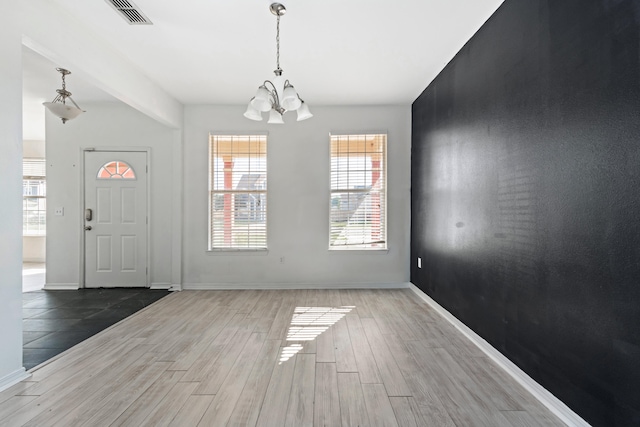 entryway with an inviting chandelier and hardwood / wood-style floors