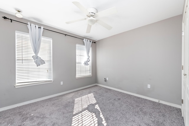 carpeted empty room featuring ceiling fan