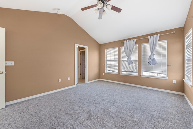 carpeted spare room featuring ceiling fan and lofted ceiling