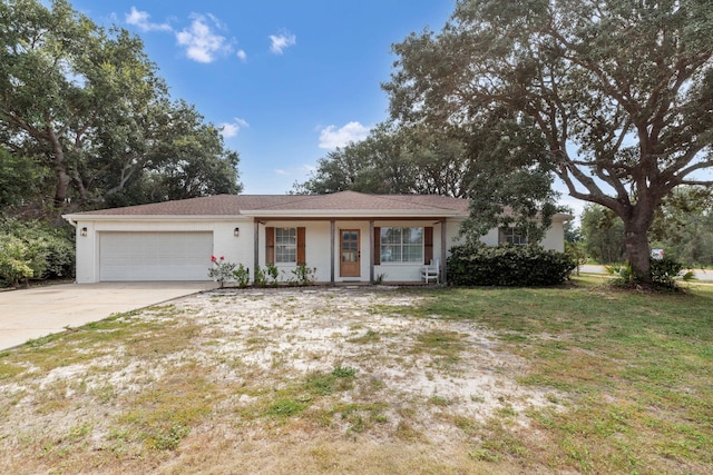 single story home with a garage and a front lawn