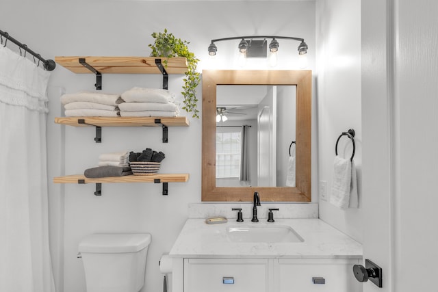 bathroom with ceiling fan, toilet, and vanity