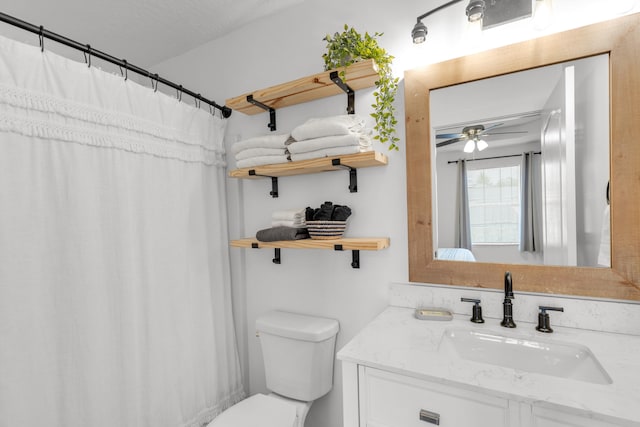 bathroom featuring ceiling fan, vanity, and toilet