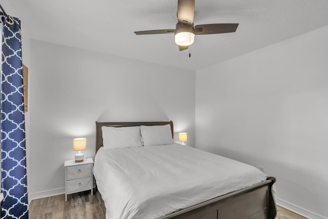 bedroom with ceiling fan and hardwood / wood-style floors