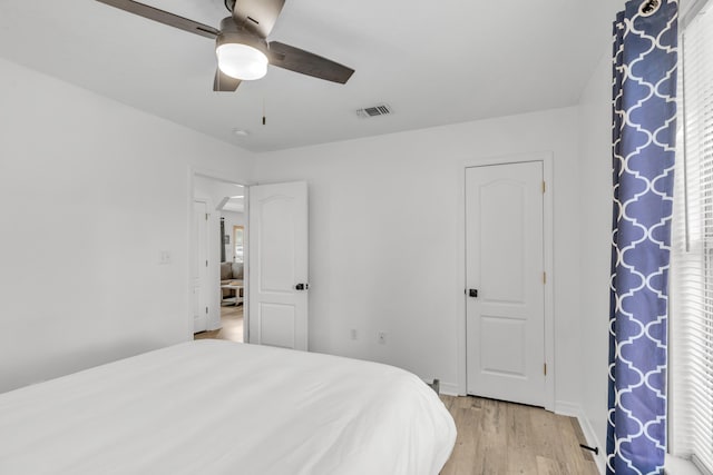 bedroom with light hardwood / wood-style floors and ceiling fan