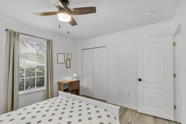 bedroom with ceiling fan, a closet, and light hardwood / wood-style floors