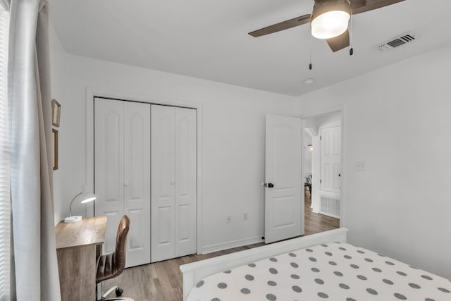 bedroom featuring light hardwood / wood-style floors, a closet, and ceiling fan