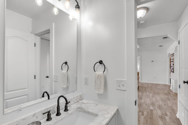 bathroom featuring hardwood / wood-style floors and vanity