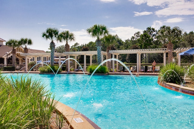 view of swimming pool with a pergola and pool water feature