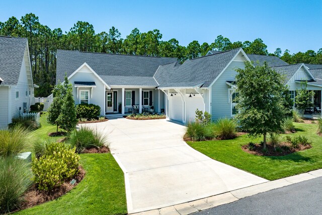 single story home featuring a garage and a front lawn