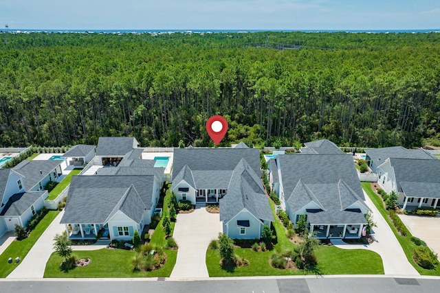 aerial view featuring a residential view and a wooded view