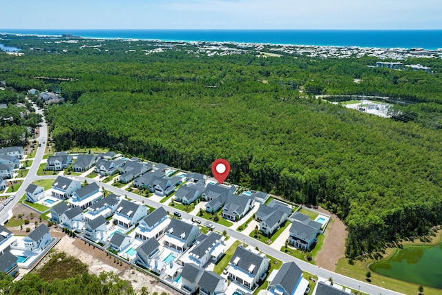 birds eye view of property with a water view, a residential view, and a view of trees