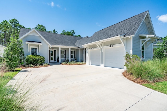 view of front of home featuring an attached garage, concrete driveway, and roof with shingles