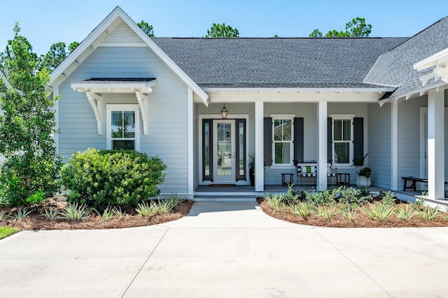 view of front of house with a porch and roof with shingles