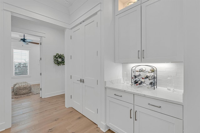 corridor with baseboards and light wood-style floors