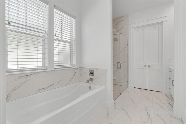 bathroom with a wealth of natural light, tile patterned flooring, and plus walk in shower