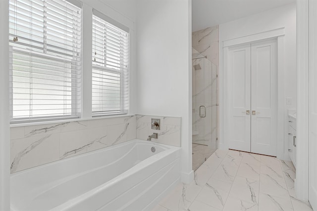 full bathroom featuring marble finish floor, a garden tub, and a marble finish shower