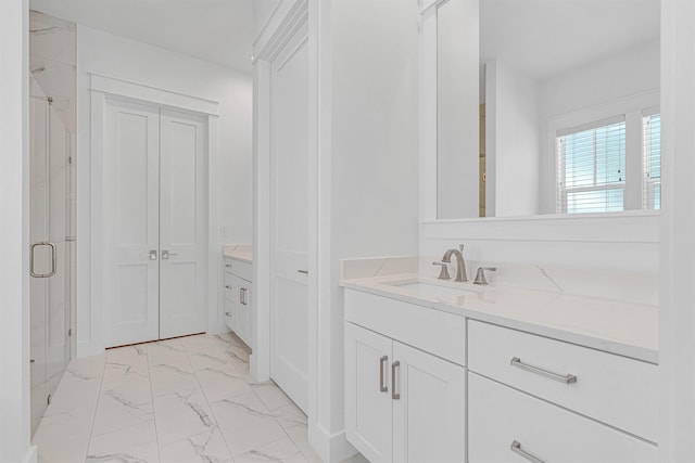 full bathroom featuring marble finish floor, a closet, and vanity