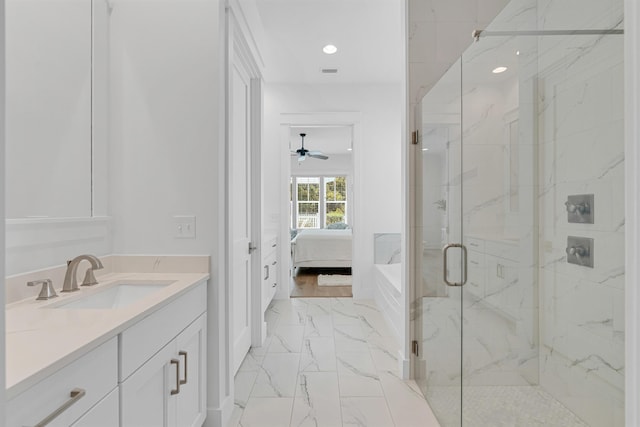 ensuite bathroom featuring a marble finish shower, ensuite bathroom, marble finish floor, vanity, and recessed lighting