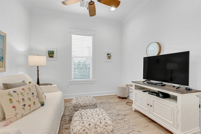 living room with ceiling fan, light hardwood / wood-style flooring, and crown molding