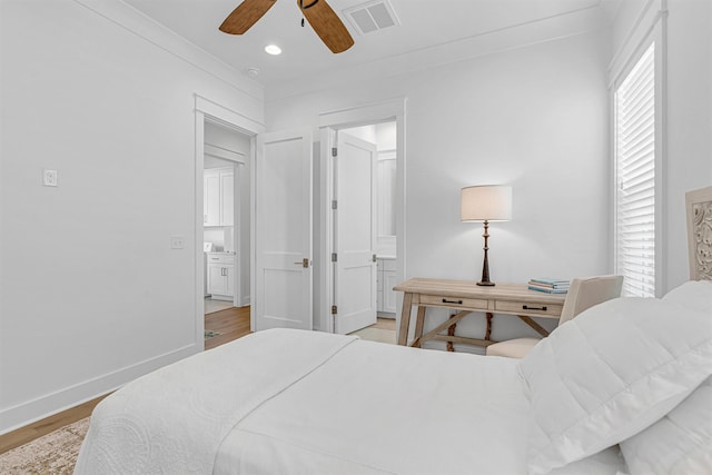 bedroom with light wood finished floors, multiple windows, visible vents, and baseboards