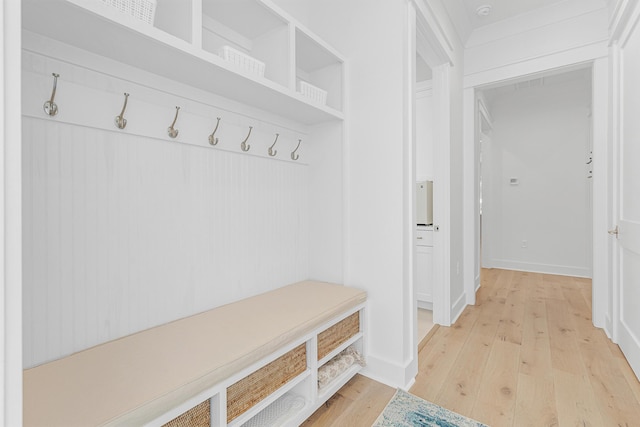 mudroom featuring baseboards and wood finished floors