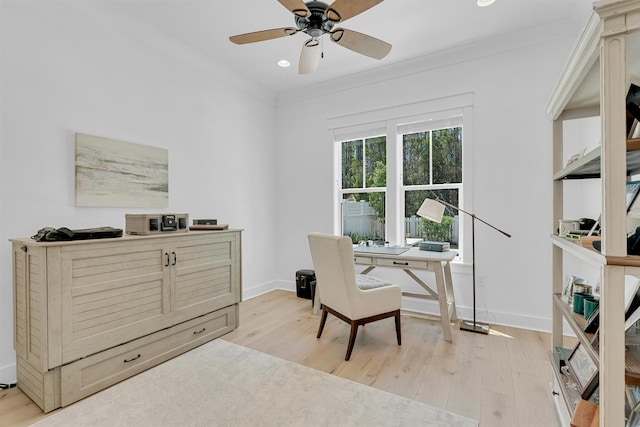 office featuring ornamental molding, light wood-type flooring, ceiling fan, and baseboards