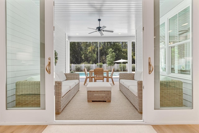 sunroom / solarium featuring ceiling fan