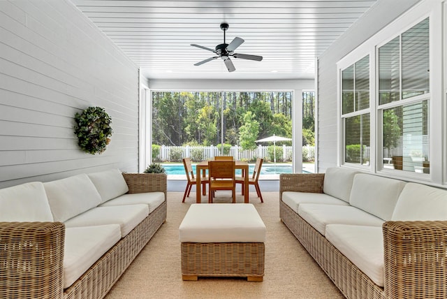 sunroom / solarium featuring a ceiling fan