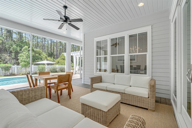 sunroom featuring ceiling fan and a healthy amount of sunlight